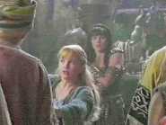 A Gabrielle look-alike defends her Xena standee from a band of
marauders at a XENA convention